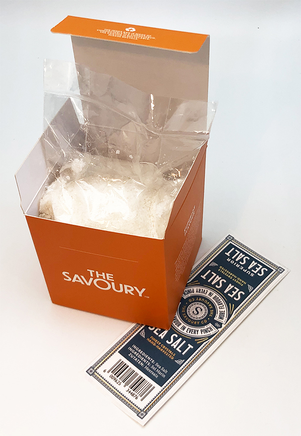 The Savoury - Orange pack with the top open standing on the top label on the Savoury Superior Sea Salt page